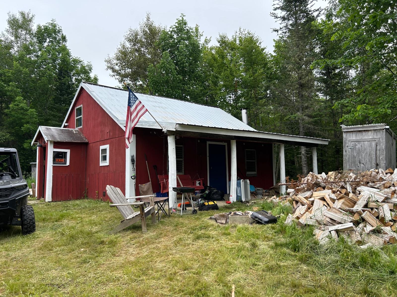 The three cabins on the property seen across the open field